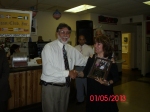 Herman Santa presenting a picture plaque to Nancy Rozon